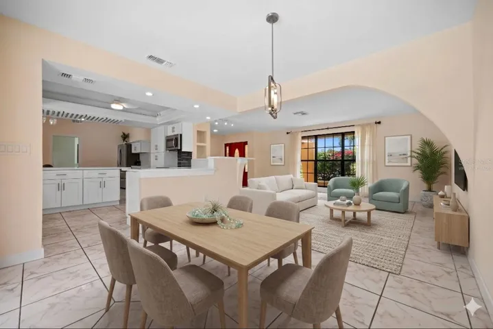 Virtually staged dining looking toward the front living area