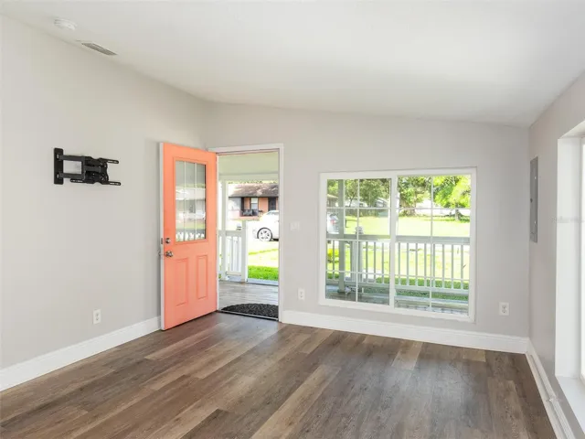Bright living area with wood-look flooring and abundant natural light.