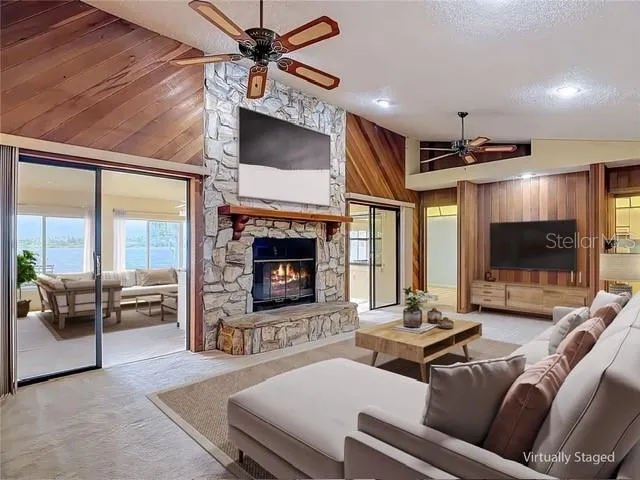 Virtual staging of living room with vaulted ceilings and fireplace.