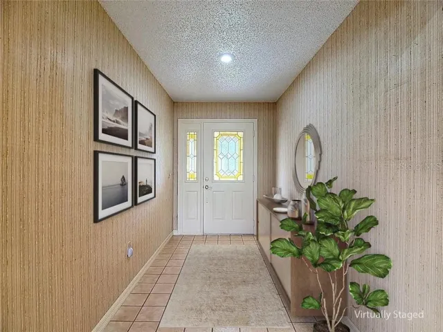 Virtual staging of welcoming foyer entry to home.