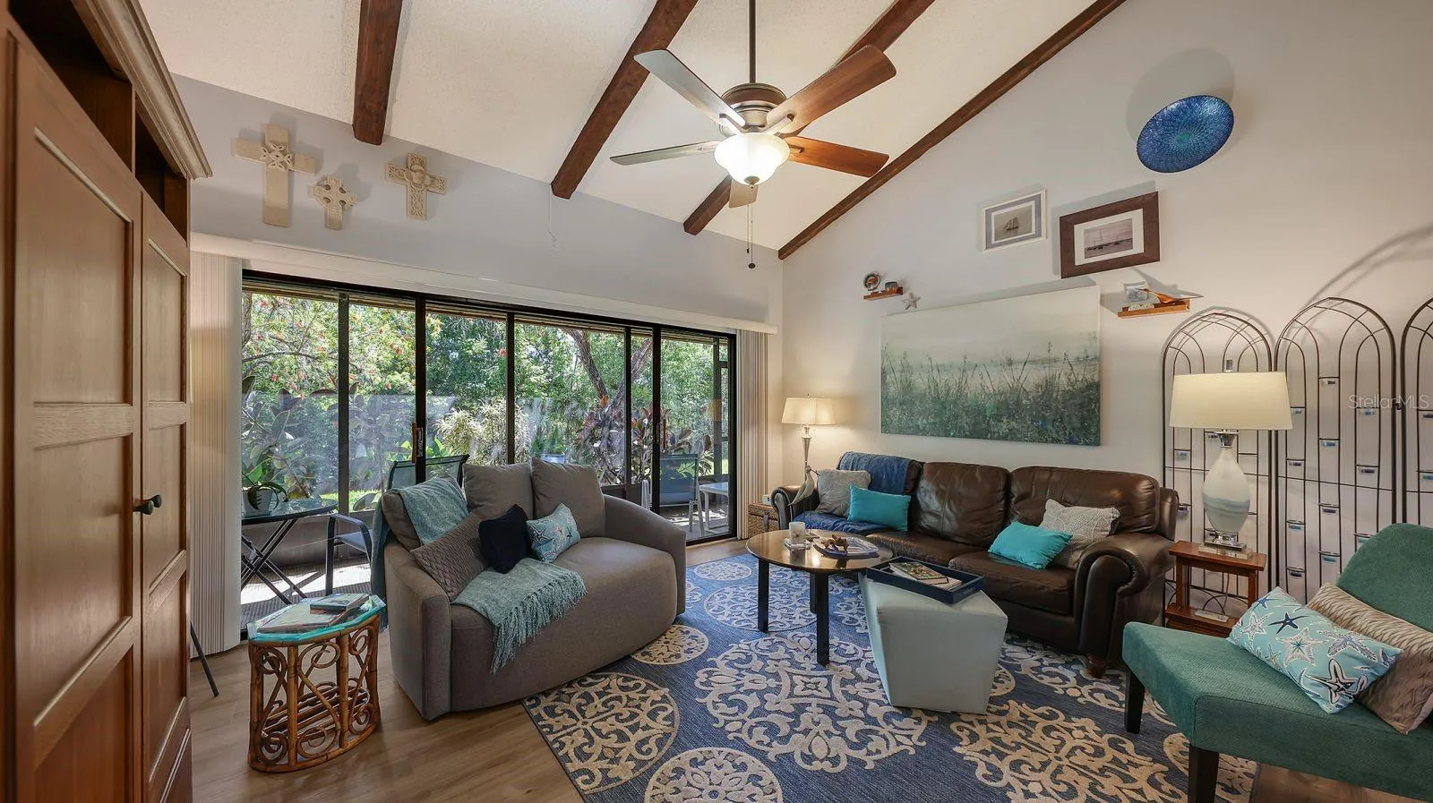 Great Room with Wood Beams and Sliders to the Screened Lanai
