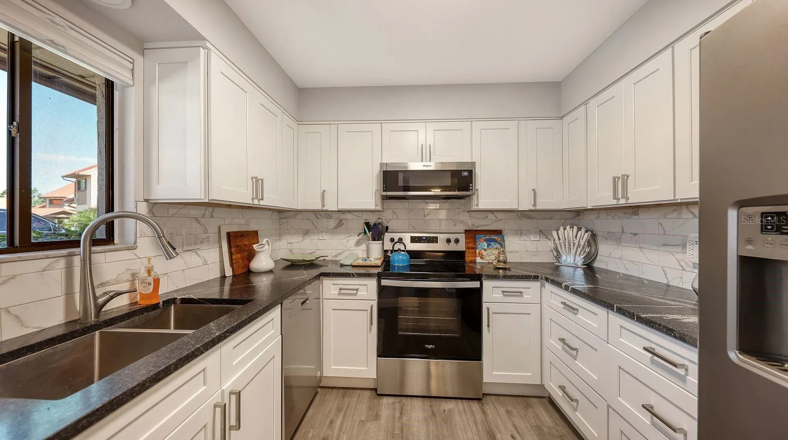 Updated Kitchen with Granite Tops, Tiled Backsplash and Stainless Appliances