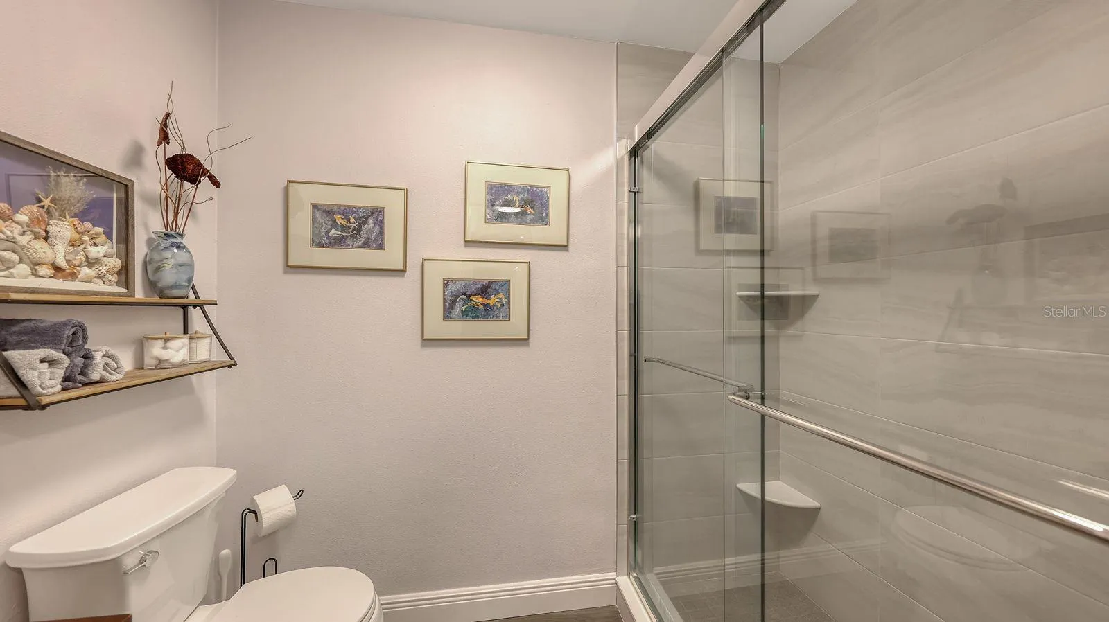 Primary Bathroom with Newly Updated, Tiled Shower with a Sliding Glass Door