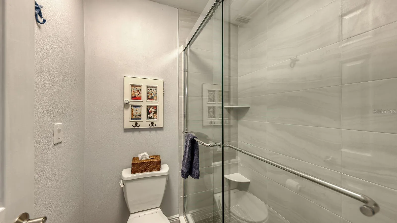 Guest Bathroom with a Newly Updated, Tiled Shower with a Sliding Glass Door