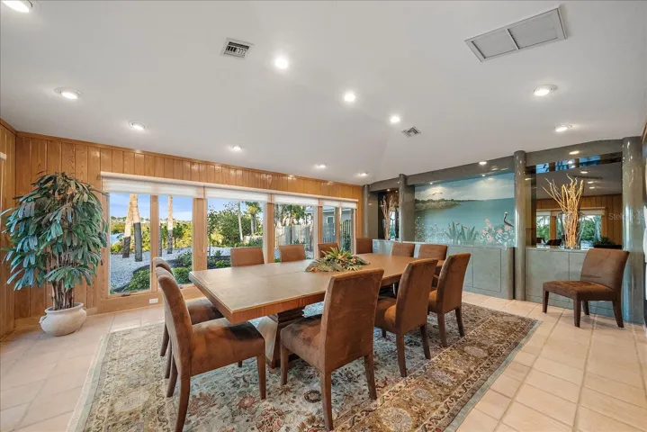 DINING ROOM with 2 full walls of windows that face Lemon Bay, CYPRESS walls, and your private dock, just a stone's throw - room for 10-12 seating easily!