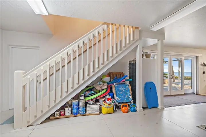 FROM THE GARAGE, the stairwell up into the extra living space (2b/1ba/living room/960sf - one bedroom has gulf views, the other bay views)