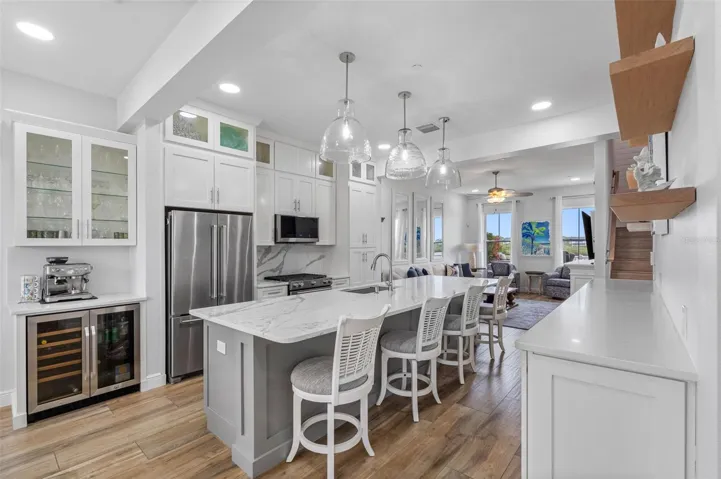 .. High Ceilings Compliment the Kitchen Area. NOTE: Upper Decorative glass front display cabinets were added with crown molding. Coffee Bar with Wine Refrigerator & Upper Glass Front Display Cabinets were also added.