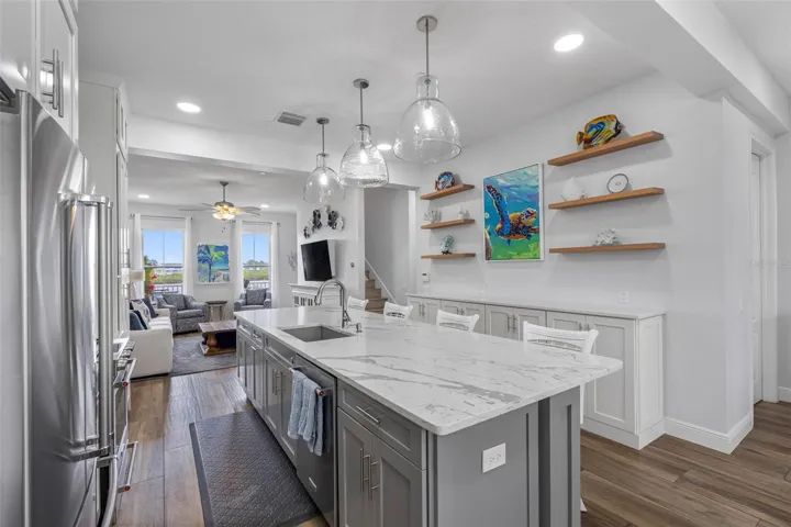 .. Kitchen Looking out to Intracoastal. NOTE: 6 Display shelves above buffet cabinets and New High End Lighting.