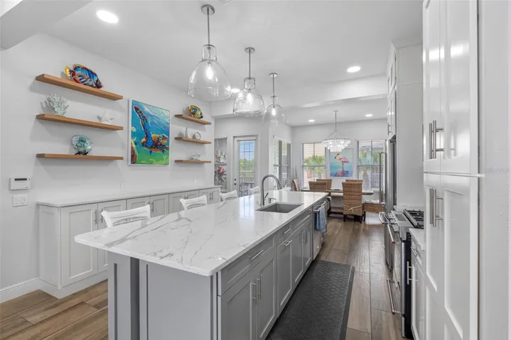 .. 18 Foot Kitchen. Perfect For Family Entertaining.. 3 Bell shaped 17 “ Recycled Glass Hand Blown Pendant Lighting over Island. Blanco Large Sink. The Owners thougt of everything here.. Perfect Family Vacation Beach Getaway.