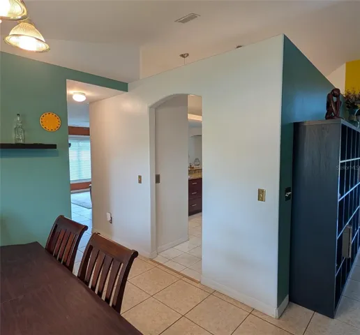 Dining room with view to Family Room left and Kitchen center