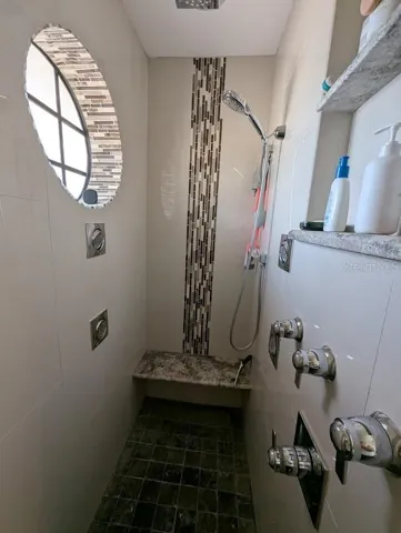 Large walk in shower has 6 shower heads