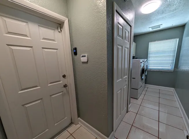 Large laundry room with entry to oversized 3 car garage