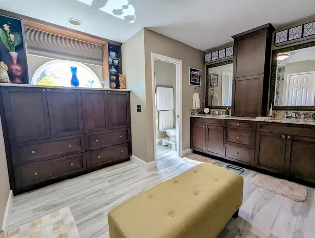 Custom cabinetry in ensuite, water closet, remote control shade