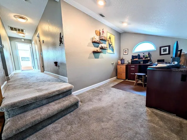 Loft and hallway leading to bedrooms and baths