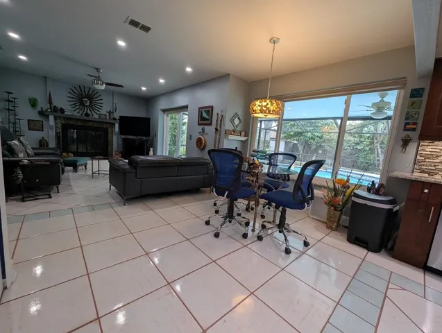 View from kitchen of family room and pool area