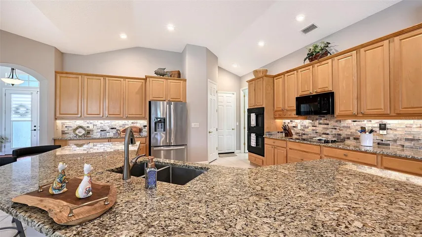 Wooden cabinets with stone countertops.