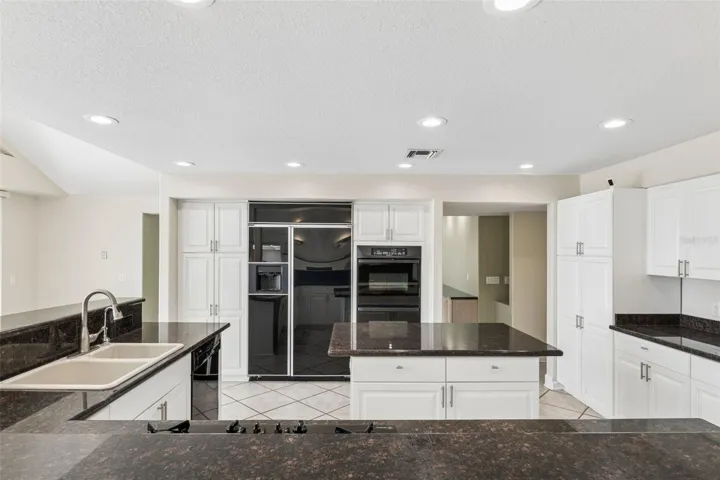 Spacious kitchen with abundant cabinetry, center island, and generous prep space for everyday living and entertaining.