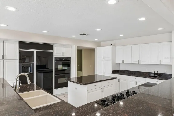 Spacious kitchen with abundant cabinetry, center island, and generous prep space for everyday living and entertaining.