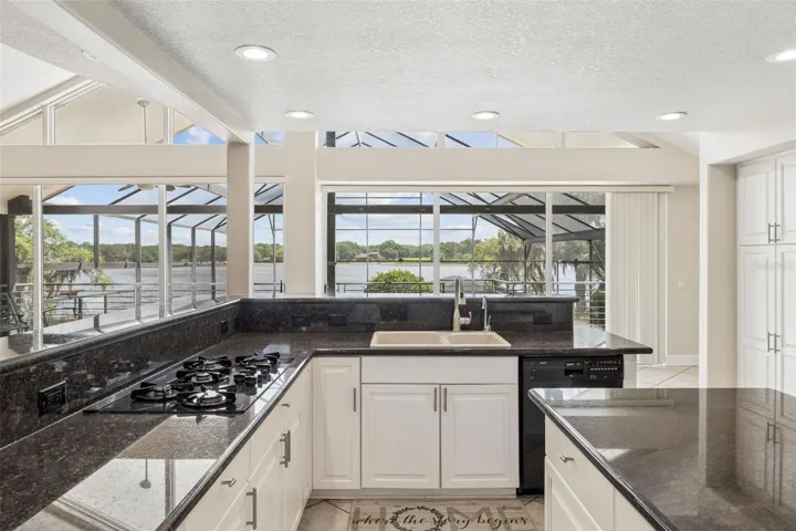 Kitchen with panoramic lake views, perfectly positioned to overlook the lanai and pool deck.