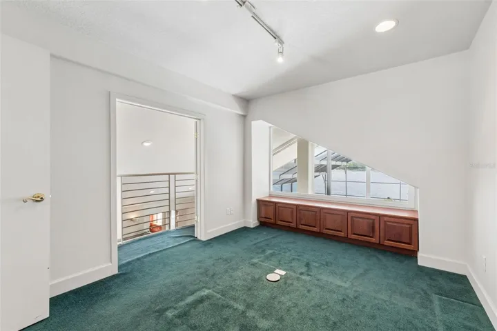 Loft office with lake views and a balcony overlook to the living room below.