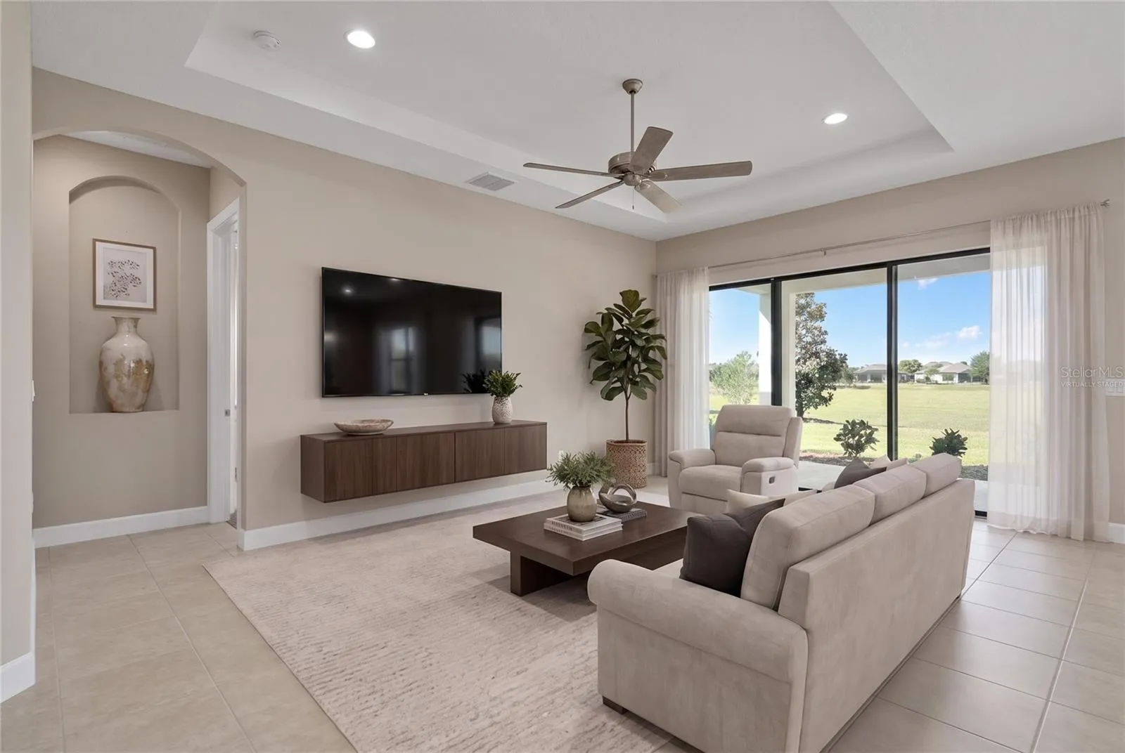 Virtually Staged- The Family Room opens to the Outdoor Living Extended Under Roof Lanai.
