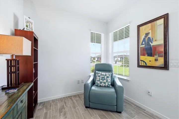 This corner window flex space (currently set as a wine room) has lots of space for any of your interests