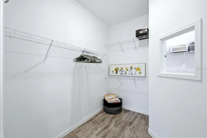 Primary closet is a good size and features the laundry pass through