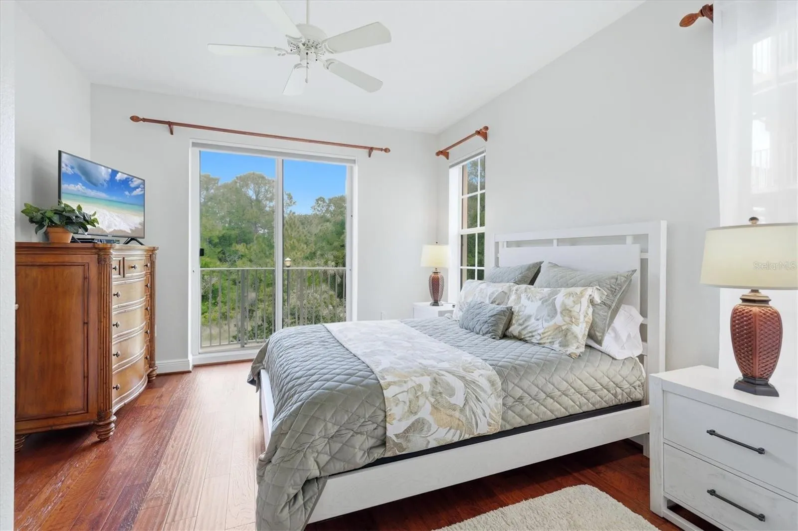 Guest bedroom 2 with large closet, and hardwood flooring