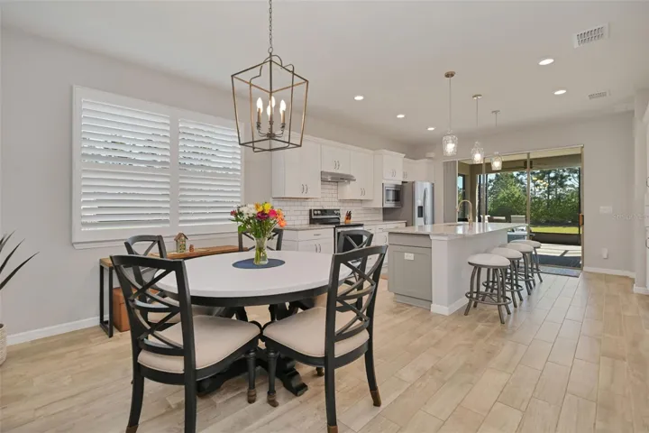 Dining Area with Stylish Chandelier and Shutters