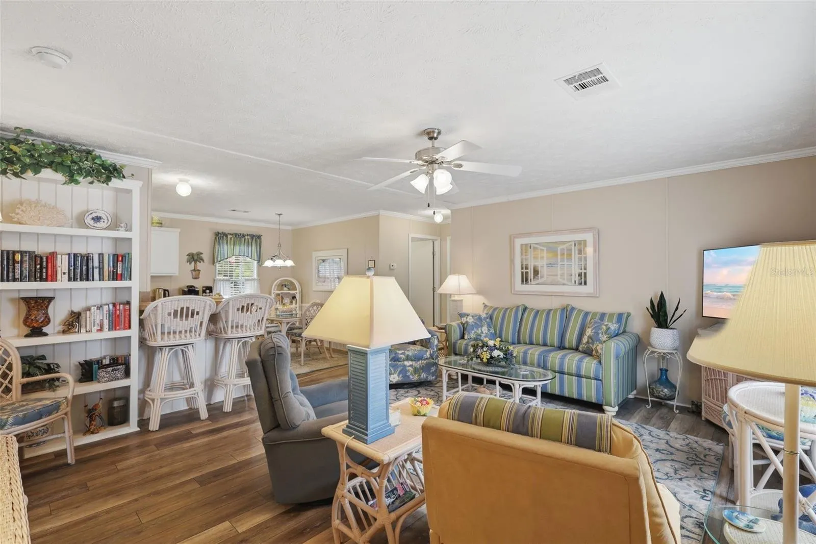 Large living space complete w/ ceiling fan and built in shelves