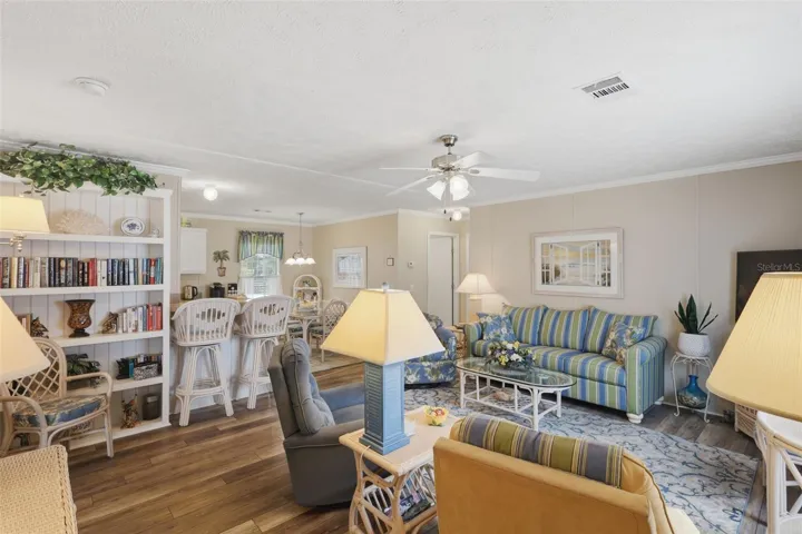 Large living space complete w/ ceiling fan and built in shelves