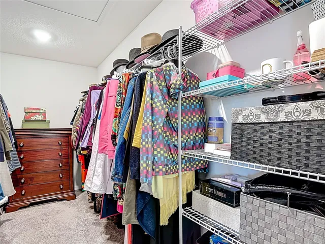 Primary bedroom walk in closet