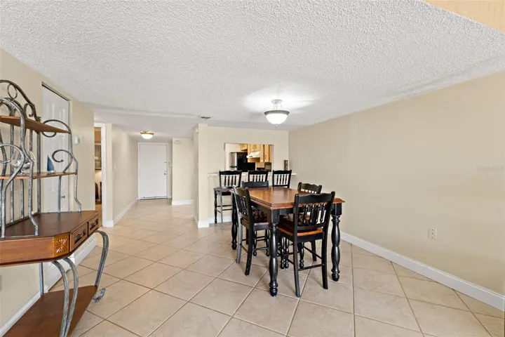 Dining area with tile flooring and direct sightlines to kitchen