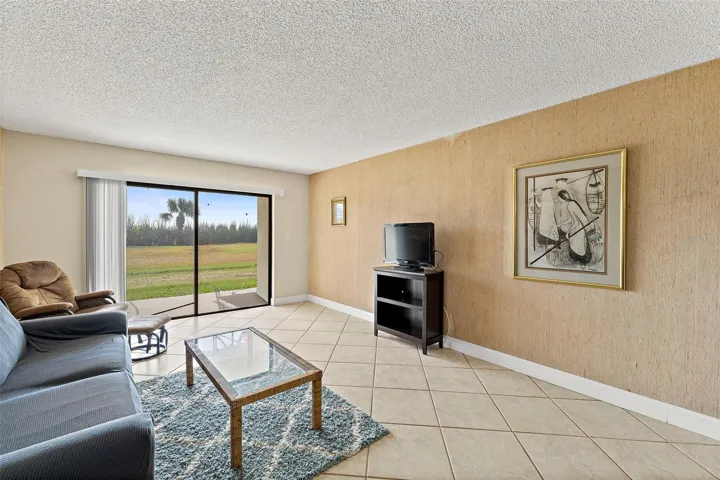 Living room with sliding glass door and views of protected coastal sea turtle nesting area