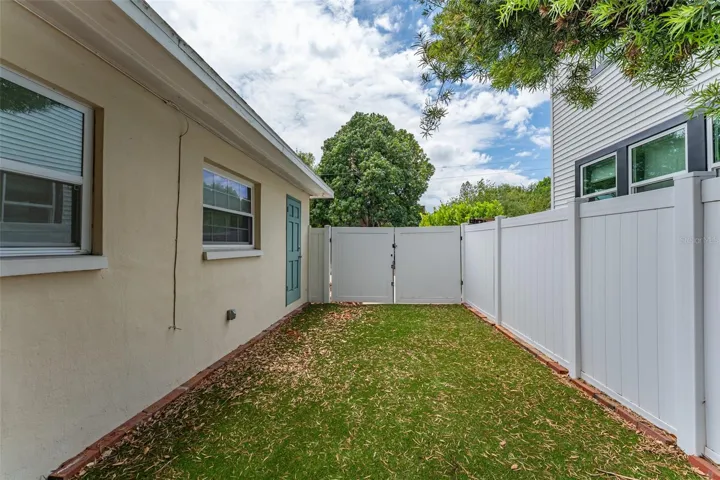 Side yard and exterior door to primary