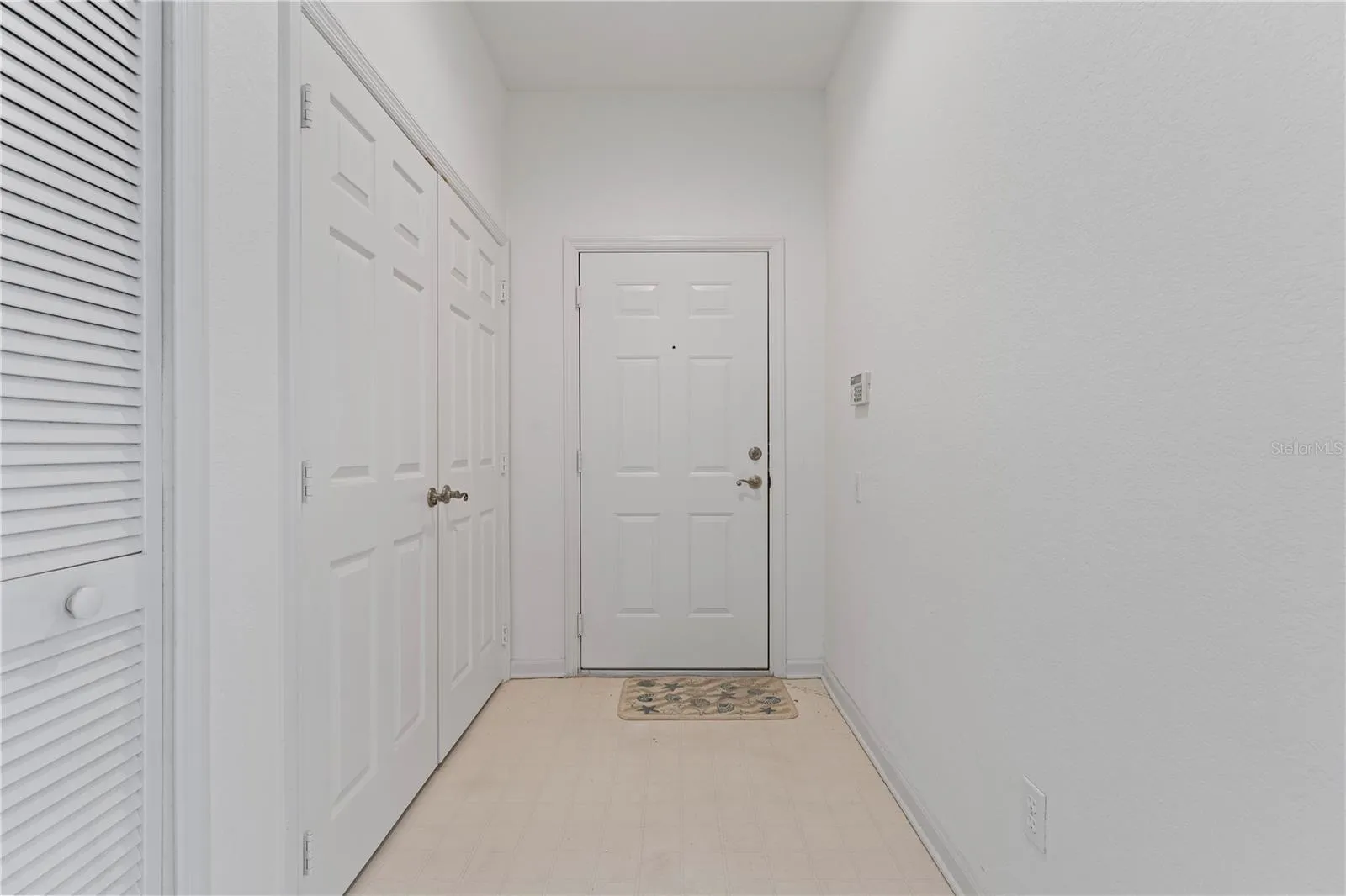 Front entrance to the condo. Laundry closet is on the left