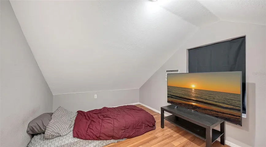 Apt #2 Attic bedroom with laminate floors
