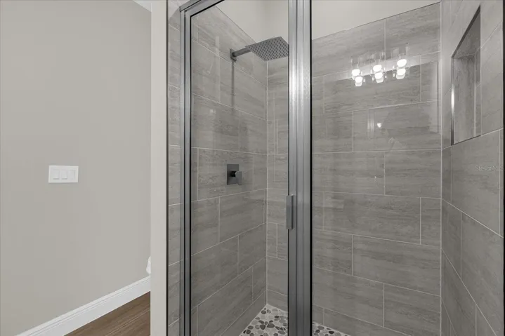Walk in glass shower in guest bathroom