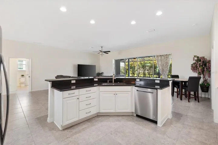 Kitchen looking toward livingroom.  Sliding doors completely recess for an unobscured view of lanai/pool area.