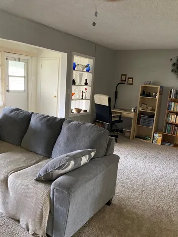 Living/dining area with back door to landscaped yard
