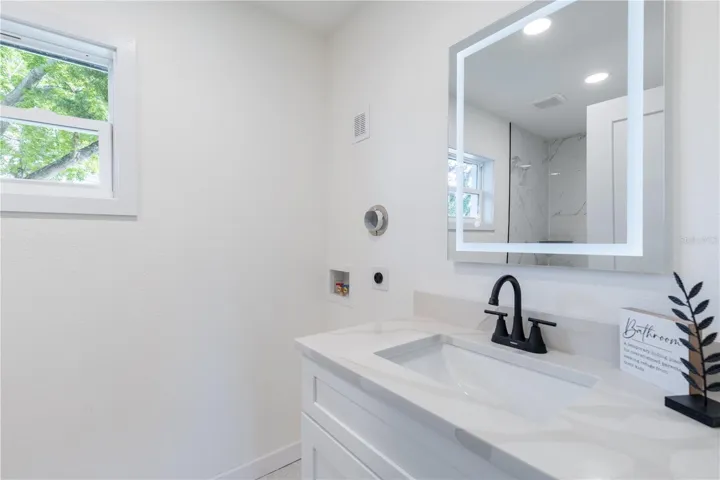 Primary bathroom with space for stackable waher and dryer