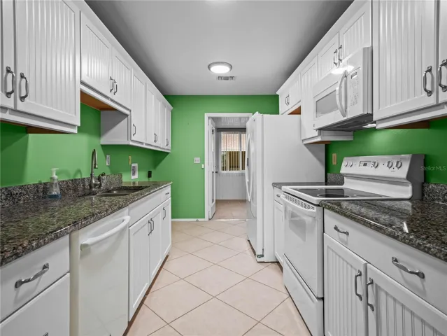 Kitchen leading into enclosed patio