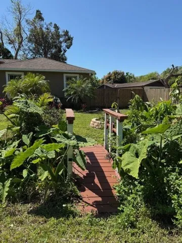 You can take this little bridge through the yard, through the gated fence and to your front door.