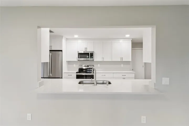Breakfast bar passthrough keeps the home chef connected!