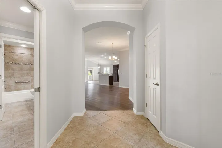To the left side of the foyer are the guest bedrooms and bath with pocket door.