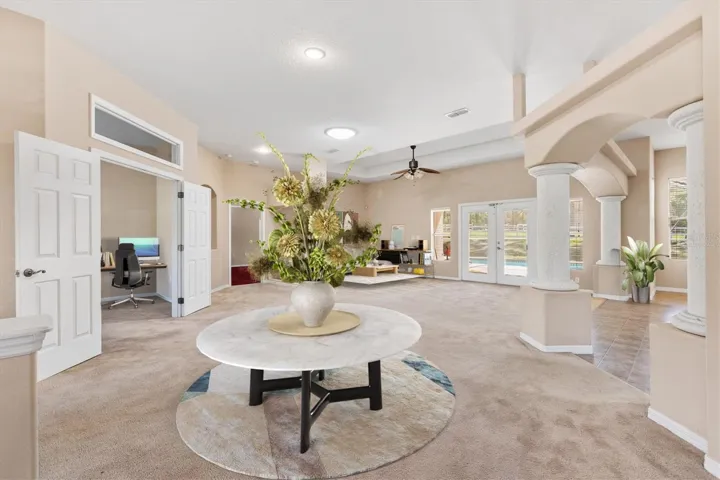 Virtually staged foyer with den/office to left of picture.