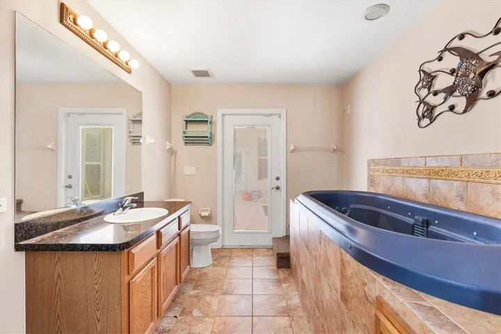 Bathroom in primary that leads out to lanai/pool area.  2 person Nordic indoor spa 130 gal 40