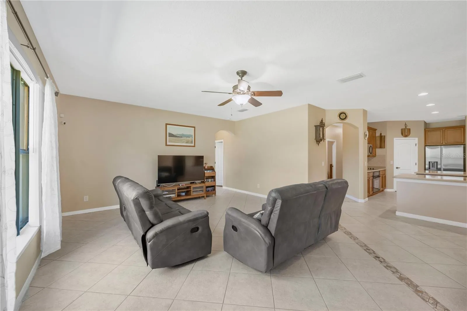 The spacious family room opens to the kitchen, creating a comfortable and inviting space for everyday living and entertaining.