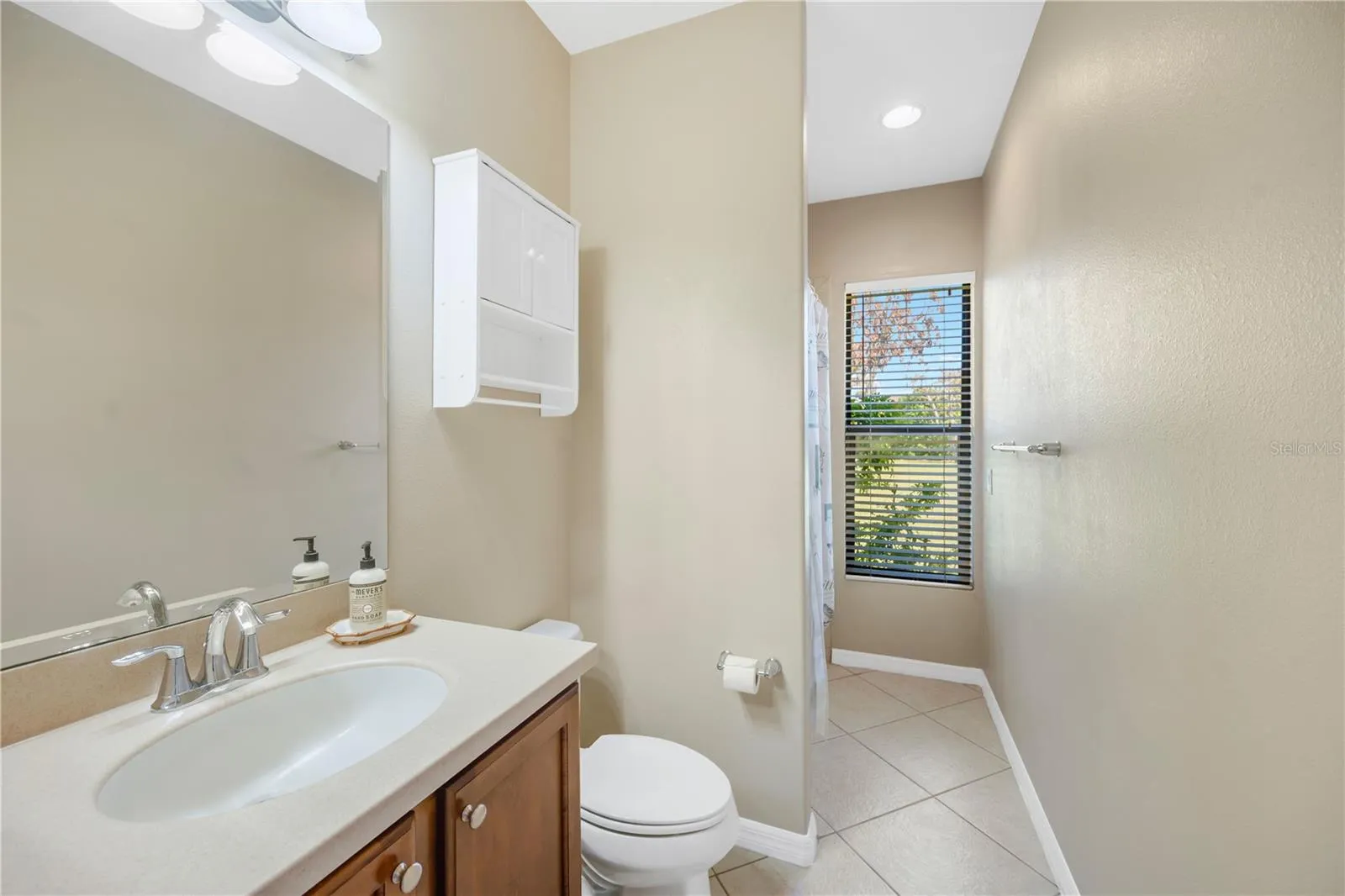 Another full bathroom with a tub/shower combination is conveniently located beside the family room and adjacent to a bedroom, making it ideal for guests or a family member seeking added privacy.
