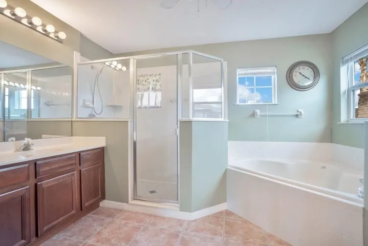 The Primary SPA-INSPIRED EN SUITE BATH includes dual vanities, a garden tub, a step-in shower, and a private water closet.